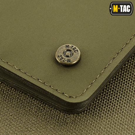 Lähikuva M-Tac Slim Elite Gen. II:stä brändatulla messinkiniitillä ja kompaktilla muotoilulla, valmistettu kulumiskestävästä polymeerikomposiitista.