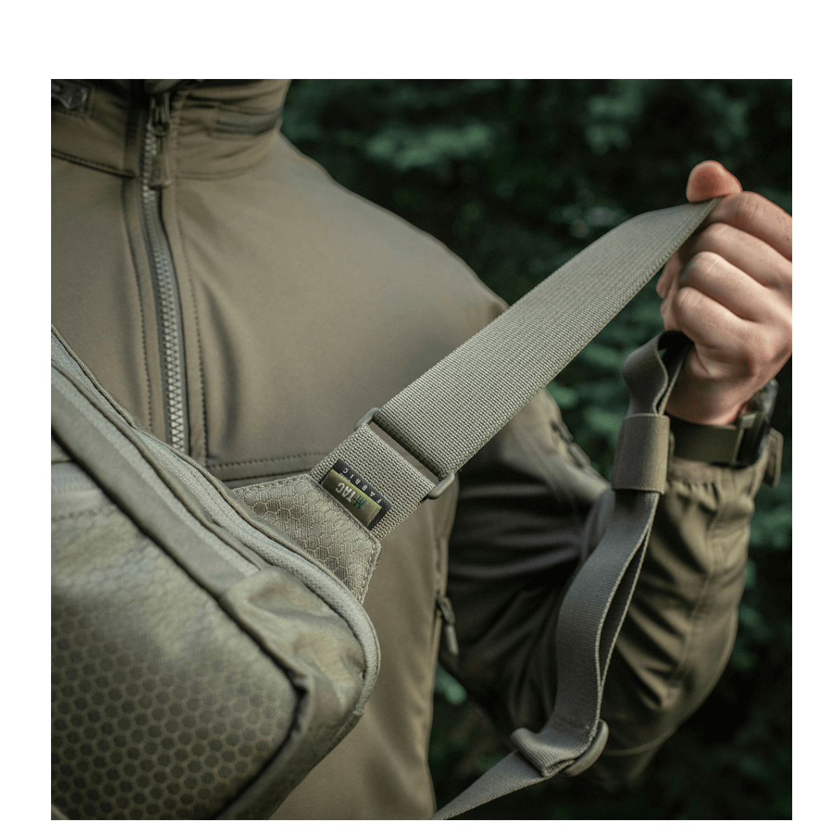 Mand bærer M-Tac Sling Pistoltaske Elite Hex med justerbar skulderrem i Cordura-materiale