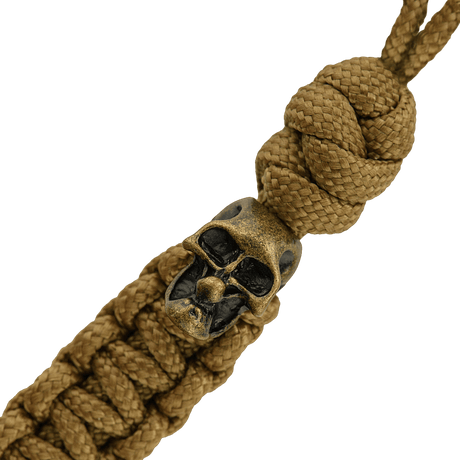 M-Tac Loopy Snake Skull Lanyard punotusta paracordista, suunniteltu veitsille ja varusteille, koristeellisella kallo-yksityiskohdalla.
