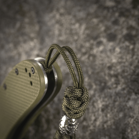 M-Tac Zeus Stainless Steel Lanyard, punottu paracord ja koristehelmi, kiinnitetty veitselle joustavaa pääsyä ja kestävyyttä varten.