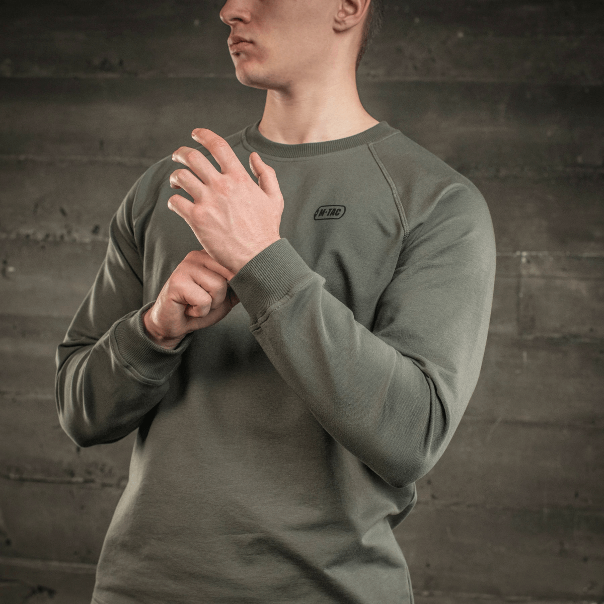 M-Tac Raglan Athlete sweatshirt med raglanærmer i olivenfarve, designet til alsidig brug og maksimal bevægelsesfrihed, set på en person.