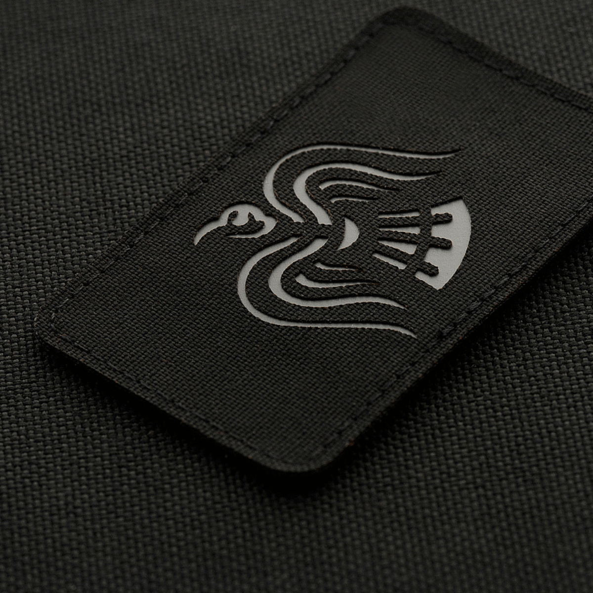 M-Tac Patch Ravneflag Laser Cut med sort ravn, symboliserer krigslyst, på sort baggrund; lavet af Cordura 500D, fastgjort med velcro.