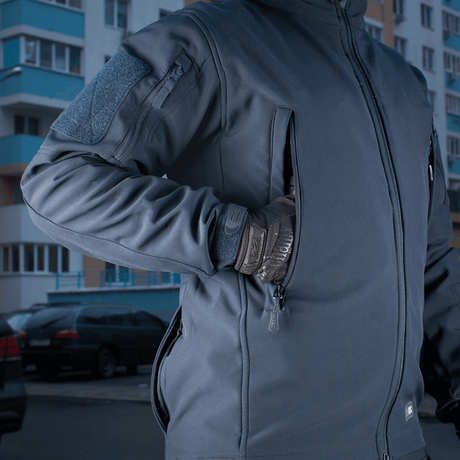 M-Tac Soft Shell Jakke med polyuretan-membran, designet til at beskytte mod dårligt vejr, indre fleece-lag, vises udendørs.