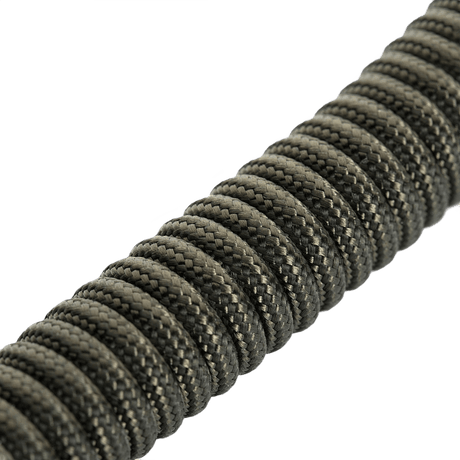 M-Tac Safety Cord med D-ring, paracord- ja PVC-spiraaliturvanyöri, suunniteltu estämään varusteiden katoamista tai varkautta.