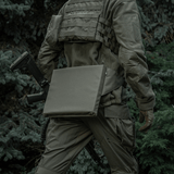 Person iført taktisk udstyr med M-Tac Siddeunderlag med bælte i skovmiljø