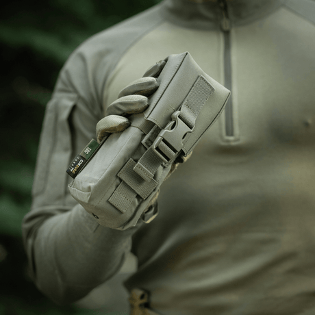 Mand holder M-Tac Dobbelt Magasin Taske med Fastex Lukning til AR og AK magasiner i robust Cordura 500D materiale, ideel til militær og outdoor.