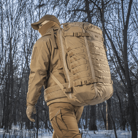 Vandrer med M-Tac Rygsæk Gen.II Elite Large i skov. Robust og alsidig rygsæk til udendørs brug fremstillet i Cordura-materiale.