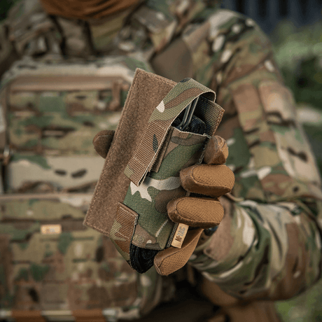 M-Tac Tourniquet Pouch Elastisk VELCRO Gen.II i camo-detaljer, monteret på en taktisk vest til hurtig adgang til C-A-T tourniquet.