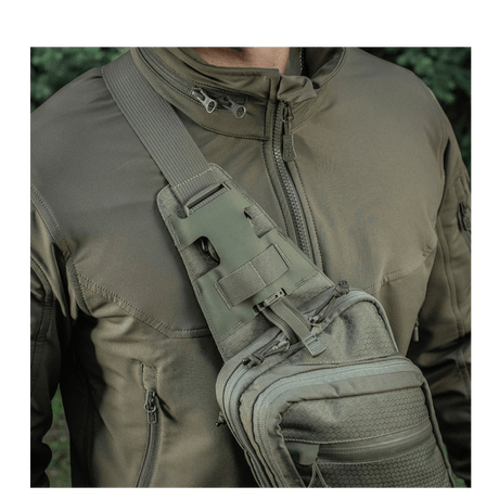 M-Tac Sling Pistoltaske Elite Hex i brug, bæret på skulder med justerbar rem og hurtigspænde, lavet af holdbart Cordura 1000D og Hex.