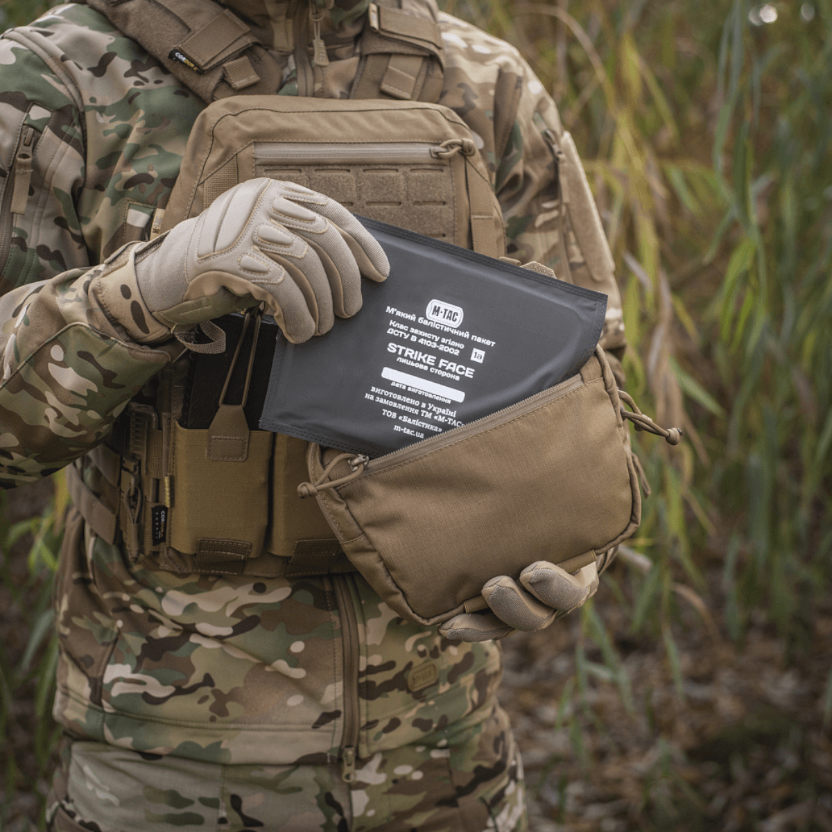 Person med camouflageuniform holder M-Tac Lomme til Tilbehør Lower Large Elite lavet af Cordura 500D.