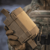 M-Tac Horisontal Medic Lomme Large Elite i corduramateriale, holdt i hånd af person iført uniform. Ideel til førstehjælp på felten.