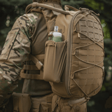M-Tac STURM Elite Rygsæk i brug, viser MOLLE Laser Cut panel og sidelomme, perfekt til taktisk brug, lavet af holdbar Cordura materiale.