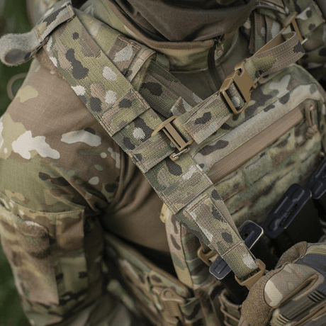 Person i camouflageuniform med taktisk vest i nærbillede, viser MOLLE Laser Cut system, der bruges til M-Tac STURM Elite Rygsæk.