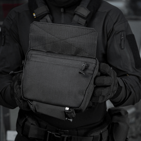 M-Tac Large Elite Gen.II Skuldertaske i brug, holdt af en person iført taktisk tøj. Fremstillet af slidstærk Cordura 500D til taktisk brug.