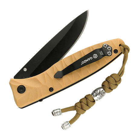 M-Tac Zeus Stainless Steel Lanyard på en kniv, flettet paracord med dekorativ stålperle, praktisk til hurtig adgang til udstyr.