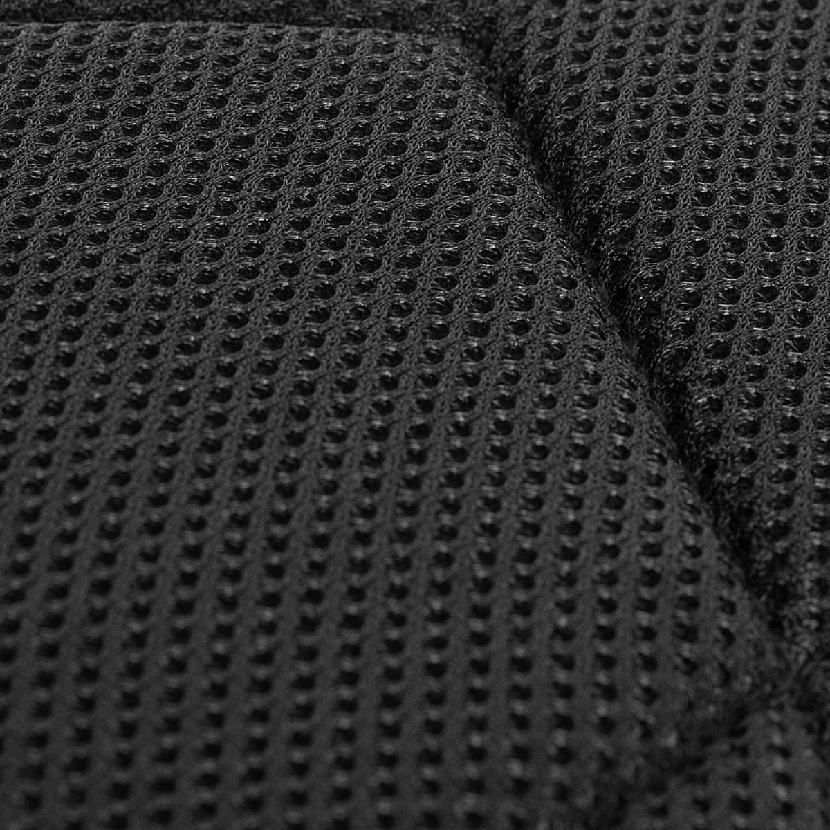 Nærbillede af åndbart mesh-materiale på M-Tac Assault Pack Laser Cut-bagside for øget komfort.