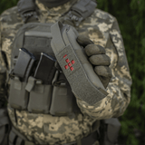 Soldat holder M-Tac Lomme til Tourniquet Closed i felten, med taktisk udstyr