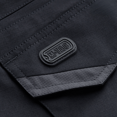 M-Tac Shorts Aggressor Gen.II Flex i mørk design, rip-stop materiale med M-Tac logo, alsidige taktiske shorts til træning og fritid.