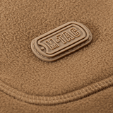 M-Tac Norman Windblock Fleecejakke emblem på brun fleece baggrund, detaljeret syning og logo synligt for kvalitet og stil.