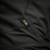 Detaljebillede af M-Tac Bukser STURM NyCo Extreme Gen.II, viser holdbar NYCO Extreme-stof og M-Tac-mærketikette.