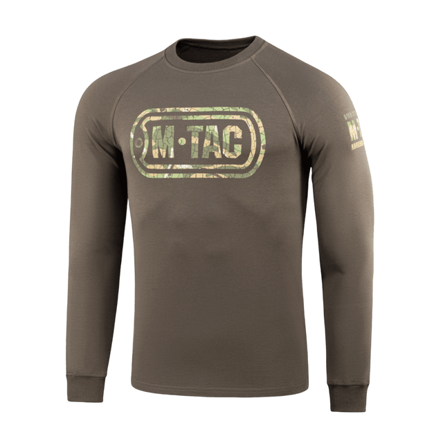 M-Tac Raglan Logo trøje med camouflageprint og "Born by Revolution – Hardened by War" slogan på ærmet. 95% bomuld, 5% elastan.