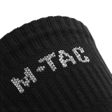 Nærbillede af M-Tac Høje Sokker Mk.2 med logo, designet til støtte og komfort under trekking.