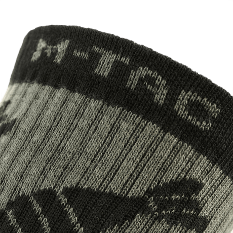 M-Tac Letvægtssokker Mk.3 Mortar Bombs i nærbillede, viser detaljerne i den lette, ergonomisk designede sok til trekking og daglig brug.