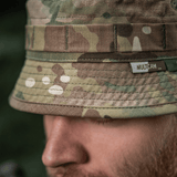 M-Tac Panama Hat Gen.II NYCO close-up, camo pattern, showcasing durable NYCO fabric and MOLLE interface, worn by person outdoors.
