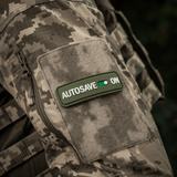 M-Tac Patch Autosave PVC på camouflagejakke, 3D morale patch med fuld farve, perfekt til tøj, rygsæk eller taktisk udstyr.