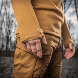 Nærbillede af M-Tac Delta Polartec Fleecejakke i skovmiljø, viser jakkeærme og hånd i brun farve.