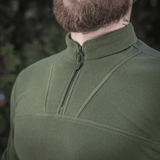 M-Tac Delta Polartec Fleecejakke i grøn farve med halv lynlås, lavet af slidstærk og varm Polartec® Micro Series-fleece til kolde dage.