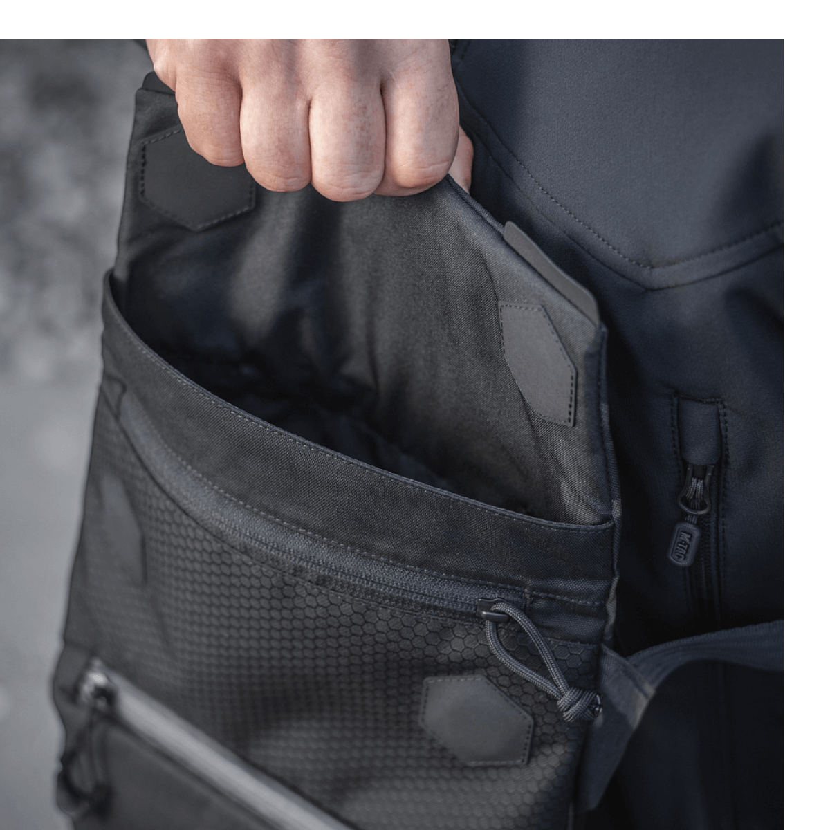 M-Tac Konvert Taske Elite med magnetventillukning i slidstærkt Cordura materiale, viser dyb lomme for nem adgang.