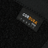 Nærbillede af Cordura stofmærke på M-Tac Sphaera Hardsling Bag Large Elite med Velcro, fremstillet af holdbare materialer.