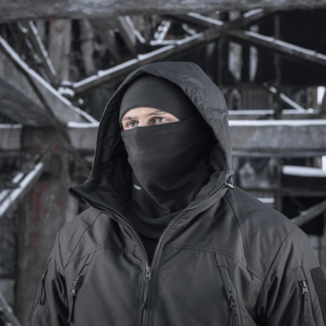 Person iført M-Tac Anatomisk Tube Scarf med Snor Polartec i et vinterlandskab