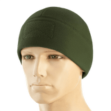 M-Tac Watch Cap Elite Fleece Beanie Hat Velcro i grøn, let og varm hue til taktisk brug med velcro-panel til mærker, bæres på mannequin.