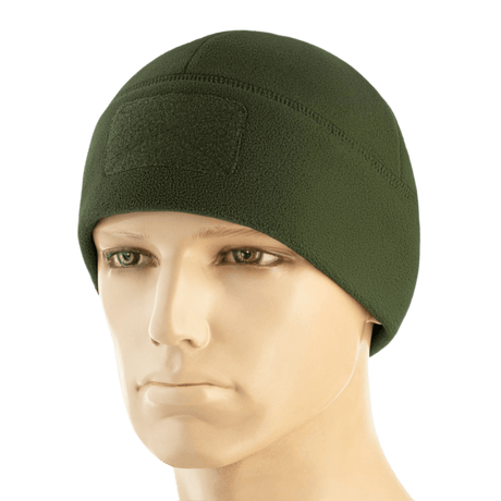 M-Tac Watch Cap Elite Fleece Beanie Hat Velcro i grøn, let og varm hue til taktisk brug med velcro-panel til mærker, bæres på mannequin.