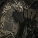 Soldat i camouflagejakke fastgør M‑Tac Patch Baba-Yaga Vertical på ærme med velcro.