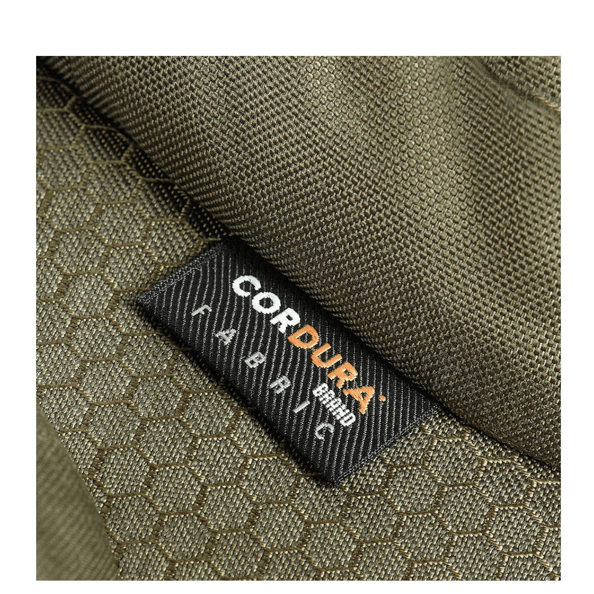 Nærbillede af M-Tac Bat Wing Taske Elite Hex med robust Cordura Hex stof i grøn farve med tekstur, fremhæver holdbarhed.